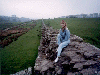 Stephanie perches atop Hadrian's Wall (05/04/99). Click here for full size image.