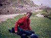 Sine beams as she relaxes at the castle ruins high atop the cliffs of Tintagel (05/09/99). Click here for full size image.