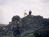 Bran and Medb climb the walls of Castell Dinas Bran and leave a treasure (05/05/99). Click here for full size image.