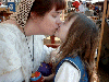 Mother and daughter share a kiss. Click here for full size image.